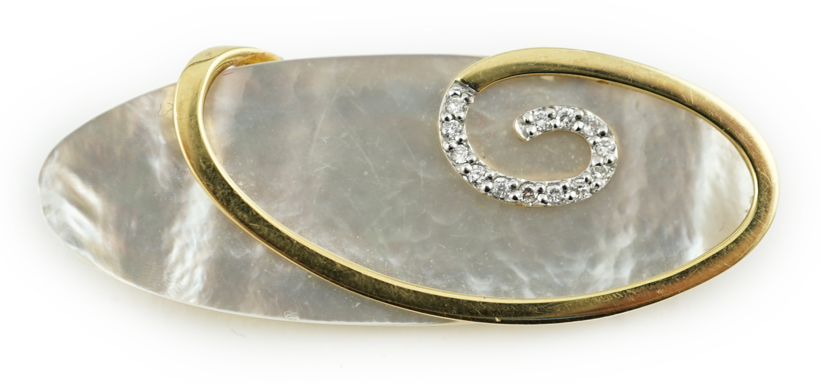 A modern stylish 18ct gold and diamond chip mounted mother of pearl brooch